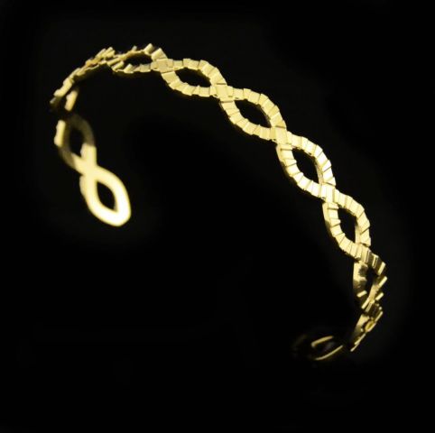 PULSERA ACERO RIGIDA ACERO OCHOS DORADO